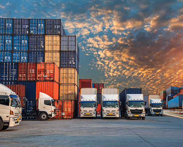 Trucks at a loading dock at sunset